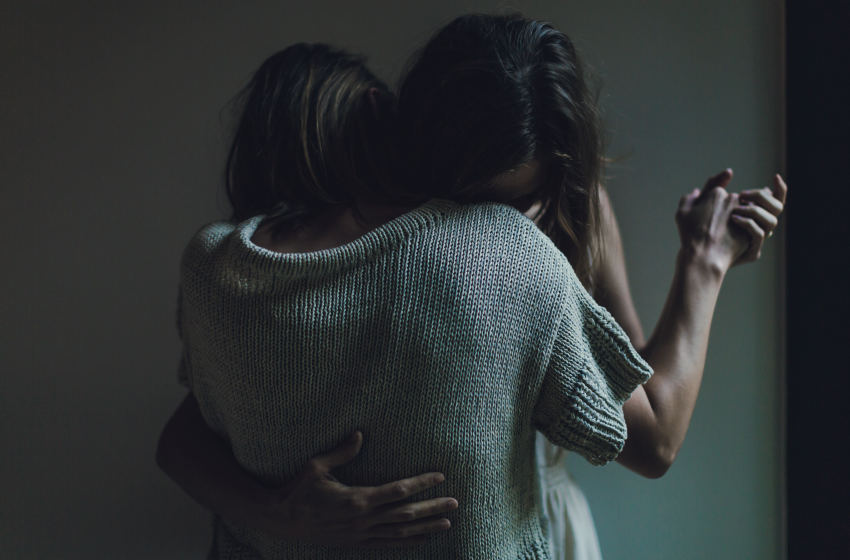 Somber couple holding each other tight - New Baby New Paltz