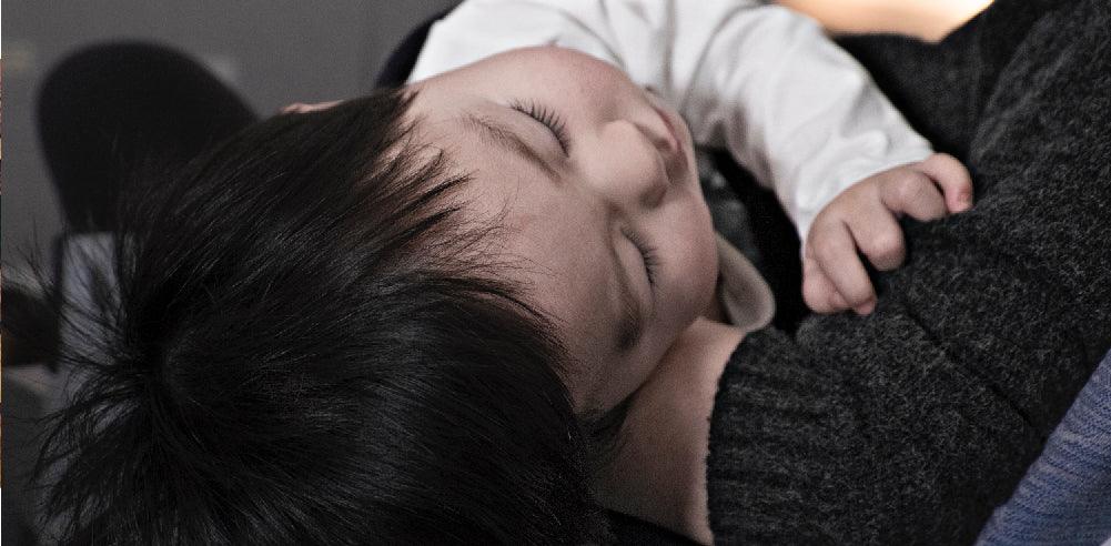 Weaned Toddler sleeping in mother's arms