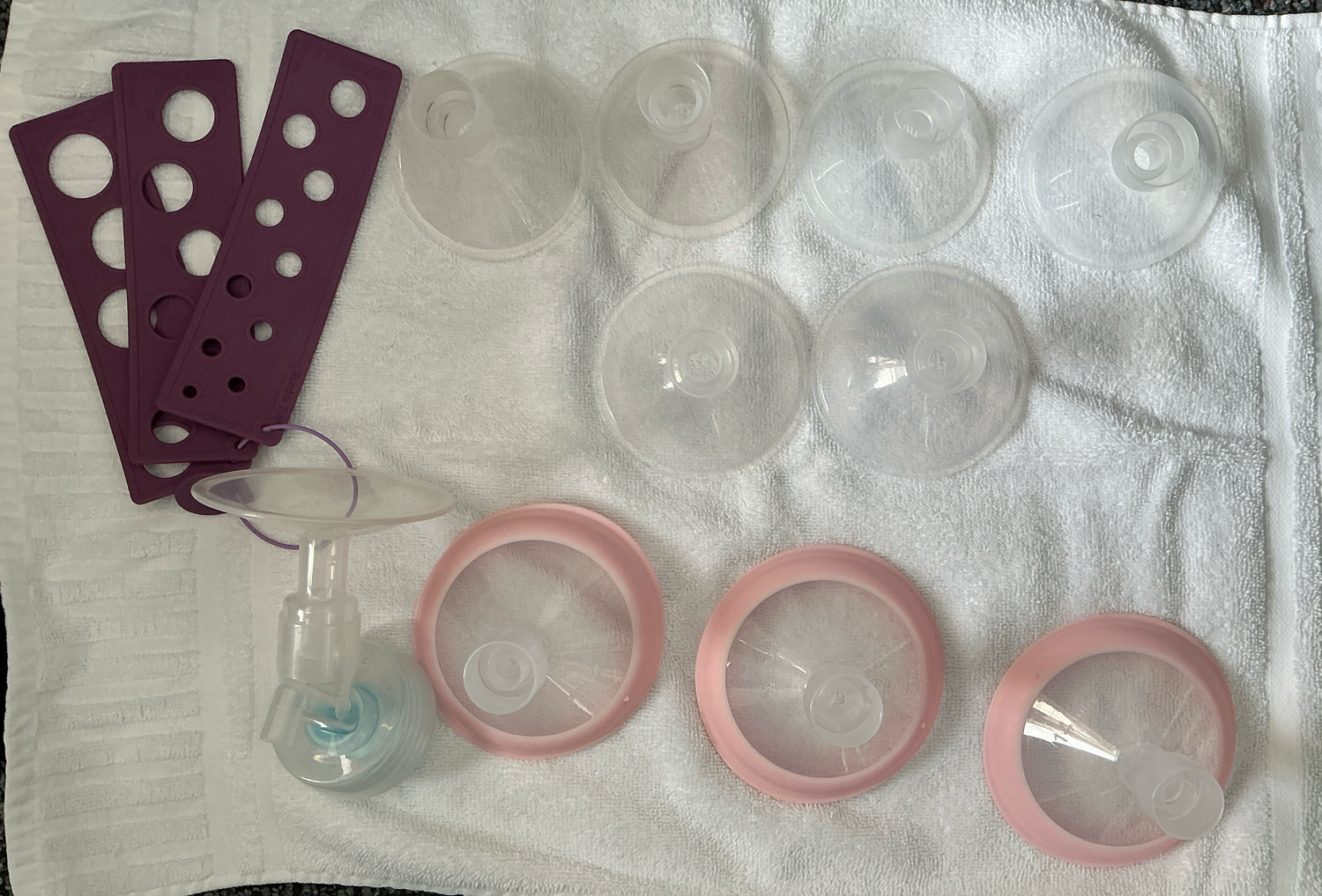 Set of breast flanges and related items on a white towel