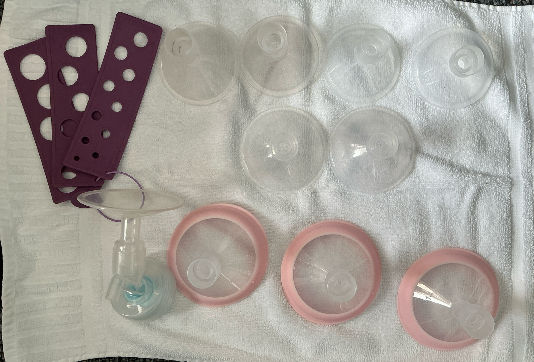 Set of breast flanges and related items on a white towel